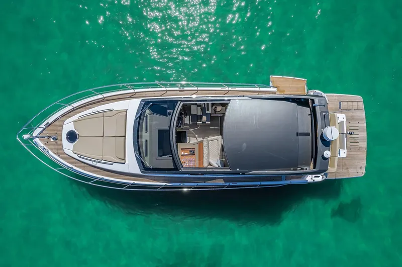 Slide: The Image of Aerial view of 2025 Schaefer 510 Sport yacht on clear turquoise water. - 4