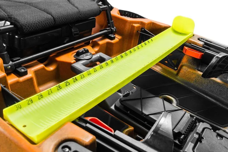 Slide: The Image of 2023 Old Town 106 Sportsman kayak with measuring board and storage compartments. - 9