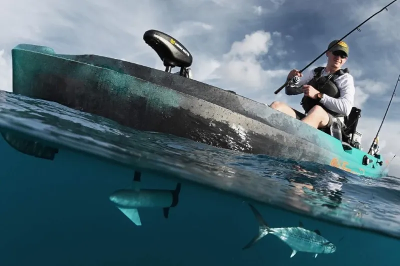 Slide: The Image of Person fishing from 2023 Old Town Sportsman Autopilot 120 kayak, with fish visible underwater. - 0