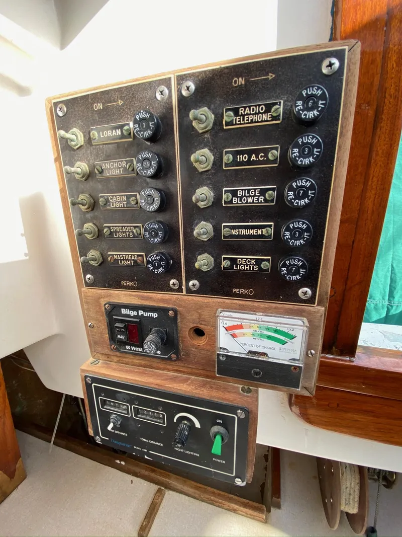 Slide: The Image of Control panel of a 1968 Pearson Wanderer sailboat with various switches and gauges. - 28