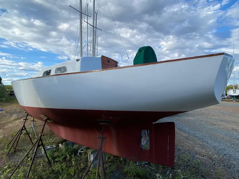 Slide: The Image of 1968 Pearson Wanderer sailboat on stands under a cloudy sky. - 3
