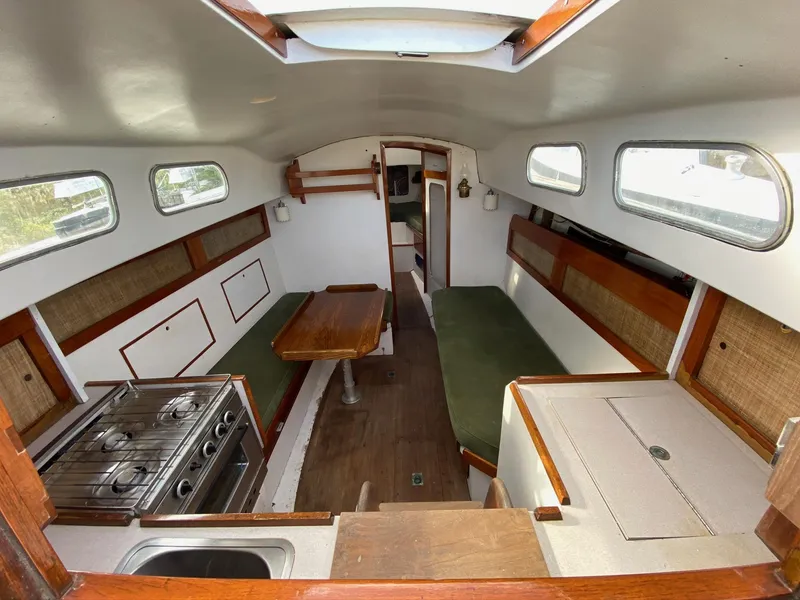 Slide: The Image of Interior of a 1968 Pearson Wanderer sailboat with kitchen and seating area. - 8