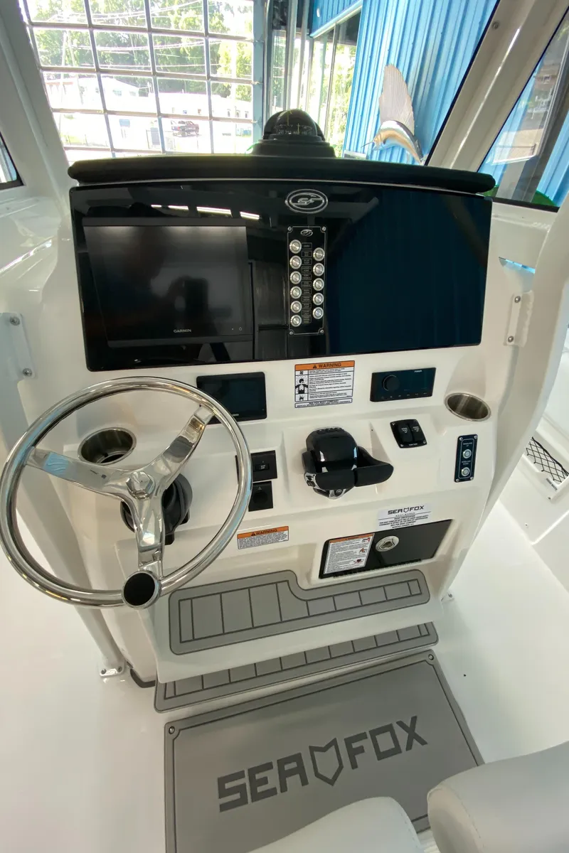 Slide: The Image of 2025 Sea Fox 268 Commander boat dashboard with steering wheel and controls. - 10