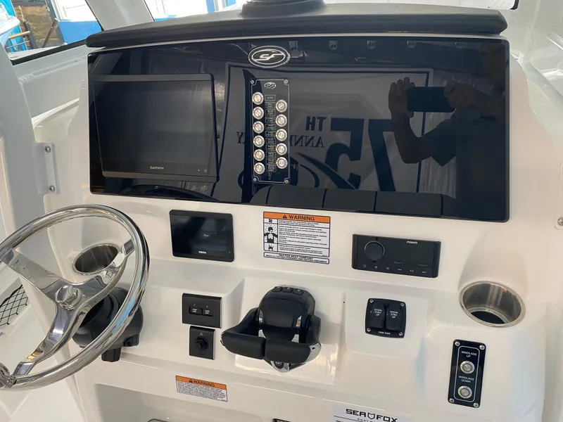 Slide: The Image of 2025 Sea Fox 268 Commander boat dashboard with steering wheel and control panel. - 16