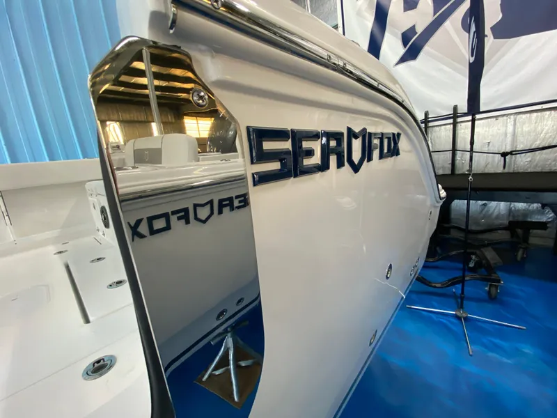 Slide: The Image of 2025 Sea Fox 268 Commander boat in showroom, sleek design with reflective surface. - 28