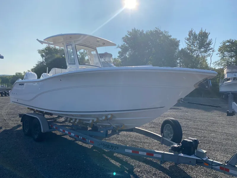 Slide: The Image of 2025 Sea Fox 268 Commander boat on trailer under bright sunlight. - 3