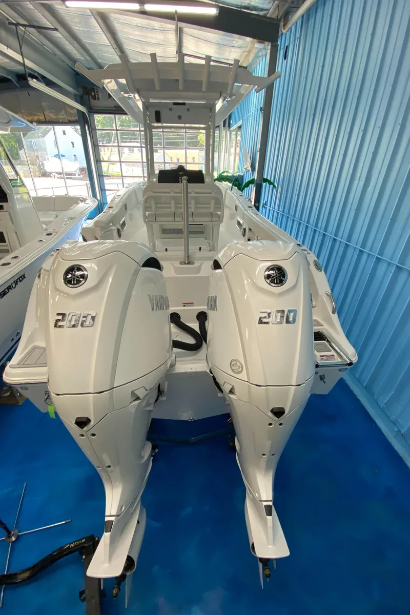 Slide: The Image of 2025 Sea Fox 268 Commander boat with dual Yamaha engines in a showroom. - 30