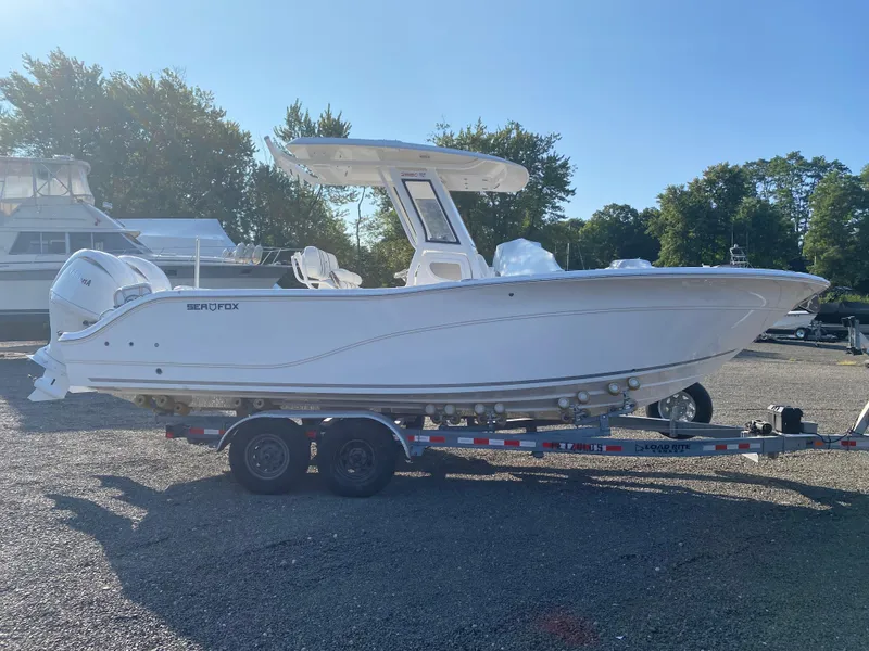 Slide: The Image of 2025 Sea Fox 268 Commander boat on trailer, parked outdoors. - 4