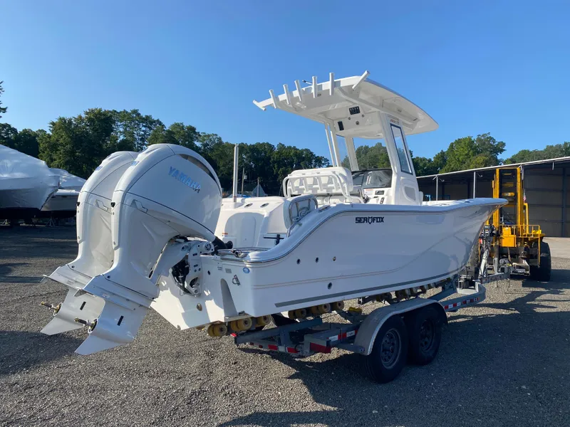 Slide: The Image of 2025 Sea Fox 268 Commander boat on trailer with dual engines, parked outdoors. - 5