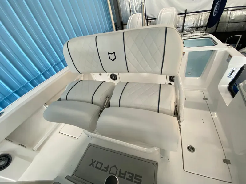 Slide: The Image of 2025 Sea Fox 268 Commander boat interior with white cushioned seating. - 7