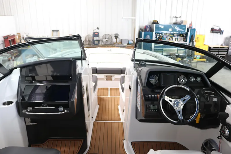 Slide: The Image of 2018 Monterey M-65 boat interior with sleek dashboard and wooden flooring. - 13
