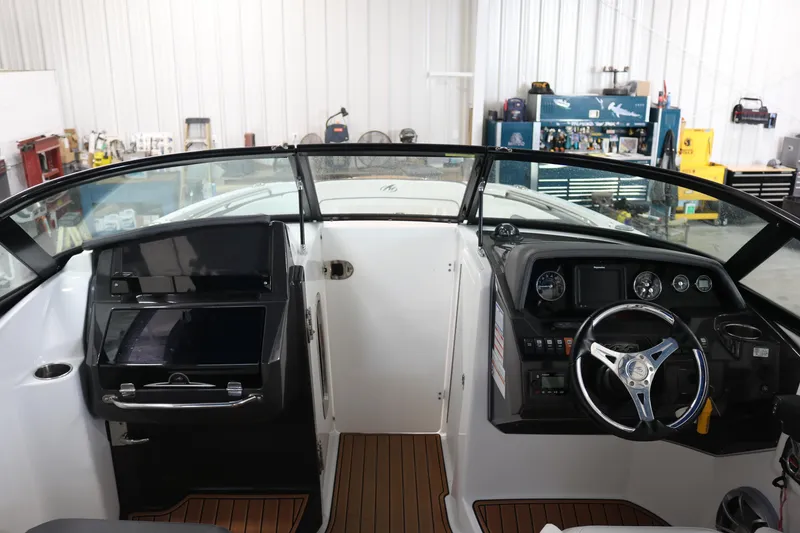 Slide: The Image of Interior view of a 2018 Monterey M-65 boat cockpit with steering wheel and dashboard. - 14