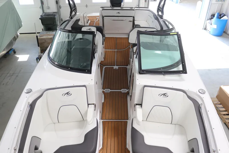 Slide: The Image of 2018 Monterey M-65 boat interior with teak flooring and white seating. - 17