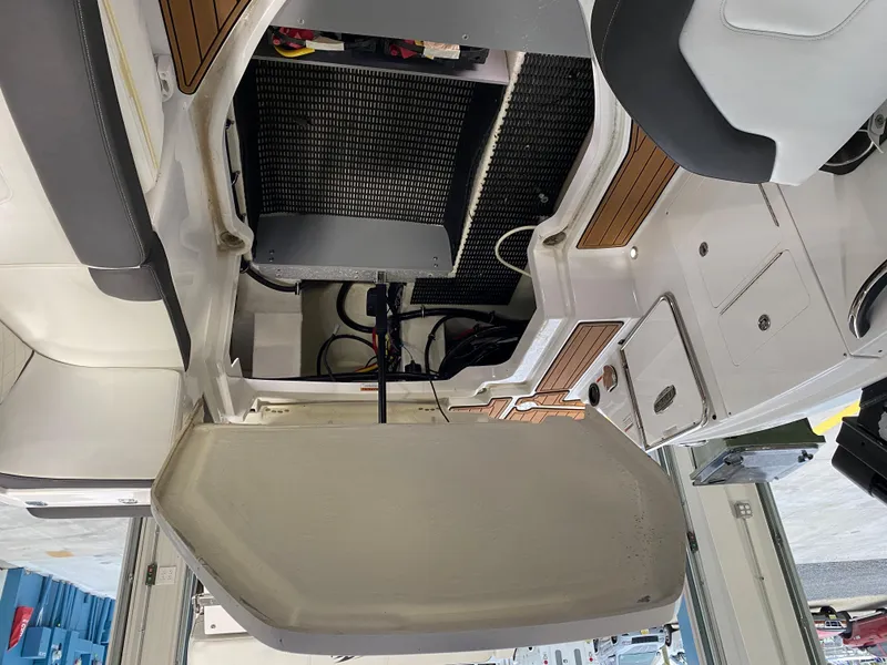 Slide: The Image of Interior view of a 2018 Monterey M-65 boat, showcasing seating and storage areas. - 19