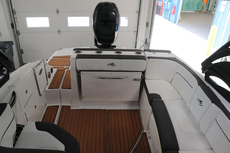 Slide: The Image of Interior of a 2018 Monterey M-65 boat with white seating and teak flooring. - 3