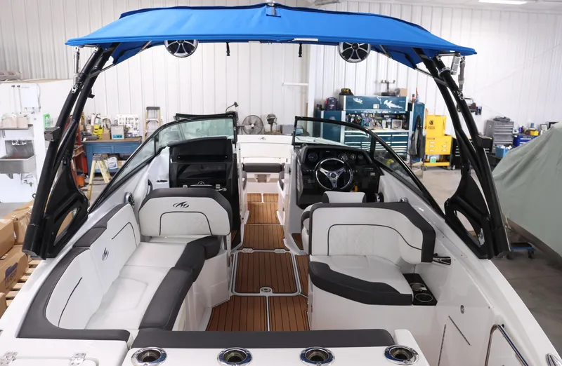 Slide: The Image of 2018 Monterey M-65 boat interior with blue canopy and modern seating. - 4