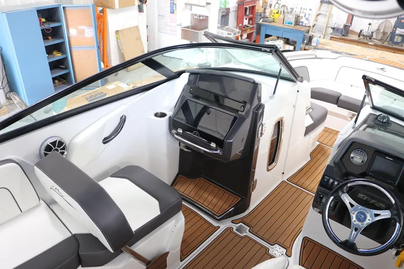 Slide: The Image of Interior of a 2018 Monterey M-65 boat with sleek design and wood accents. - 9