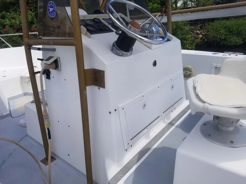 Slide: The Image of 1977 Pace Wahoo boat helm with steering wheel and control panel. - 12