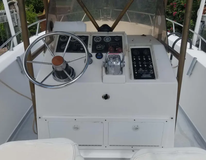 Slide: The Image of 1977 Pace Wahoo boat dashboard with steering wheel and control panel. - 15