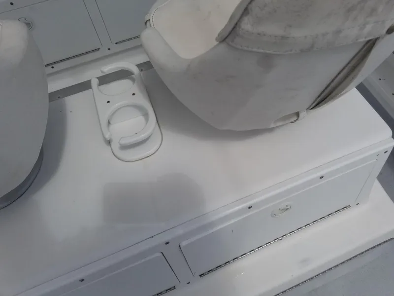 Slide: The Image of 1977 Pace Wahoo boat interior with white seating and cup holder. - 16