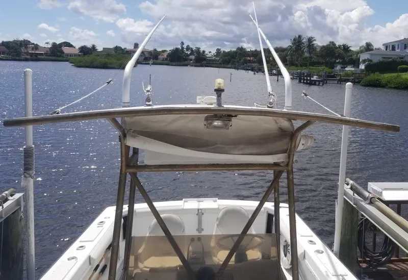 Slide: The Image of 1977 Pace Wahoo boat docked on a sunny day, overlooking a calm waterway. - 3