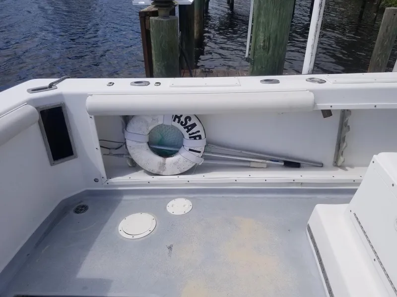 Slide: The Image of 1977 Pace Wahoo boat deck with life preserver and dock view. - 7