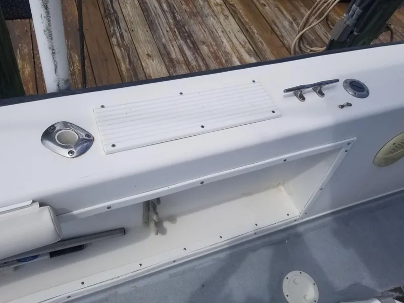 Slide: The Image of 1977 Pace Wahoo boat deck with cleat and rod holder, docked on wooden pier. - 8