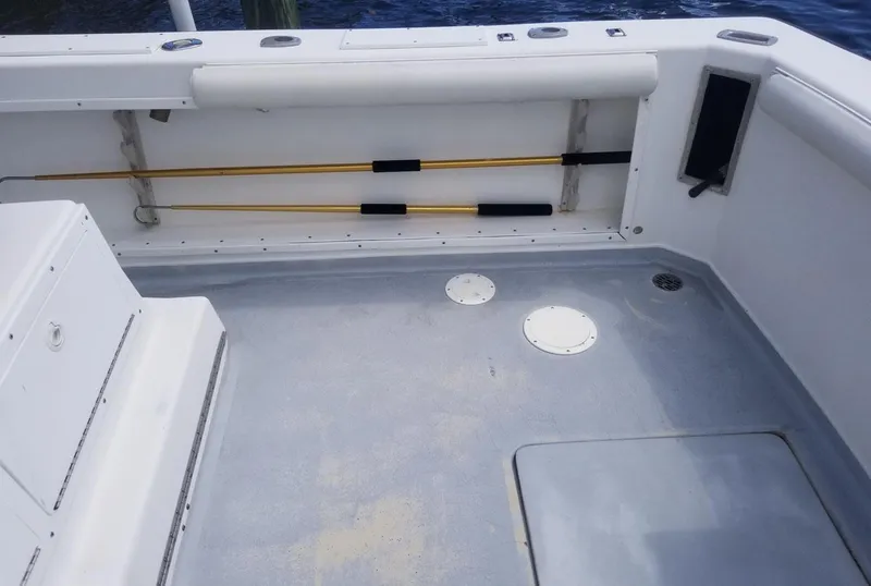 Slide: The Image of 1977 Pace Wahoo boat interior with fishing rod holders and clean deck. - 9