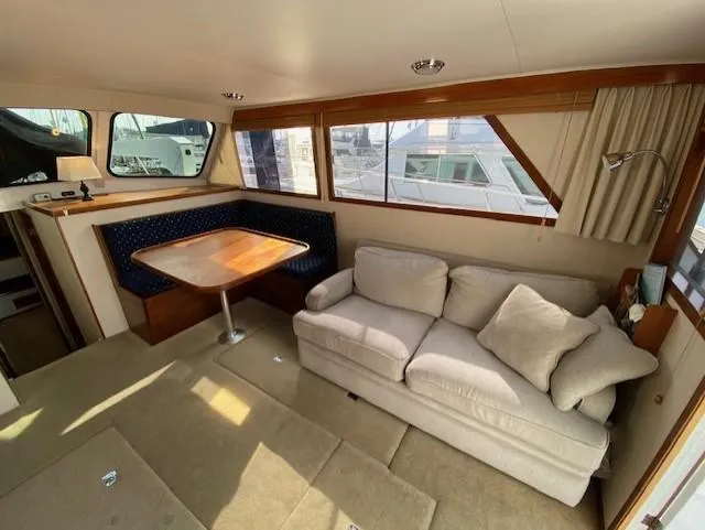 Slide: The Image of Interior of 1973 Uniflite 42 Flybridge with sofa and dining area. - 12