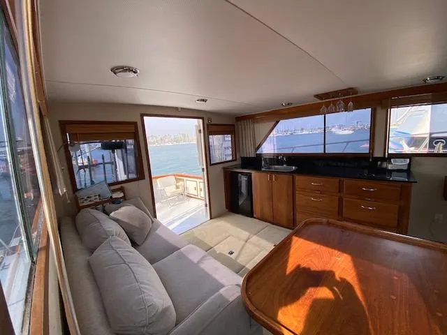 Slide: The Image of Interior of 1973 Uniflite 42 Flybridge yacht with sofa, wooden cabinetry, and ocean view. - 15