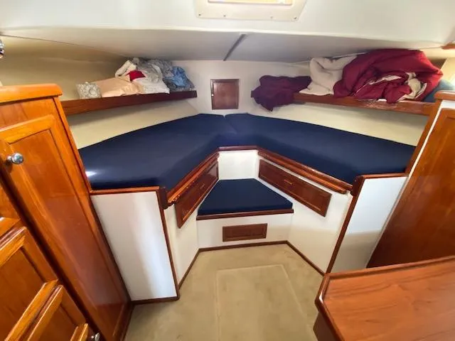 Slide: The Image of 1973 Uniflite 42 Flybridge cabin interior with wooden cabinets and blue cushions. - 16