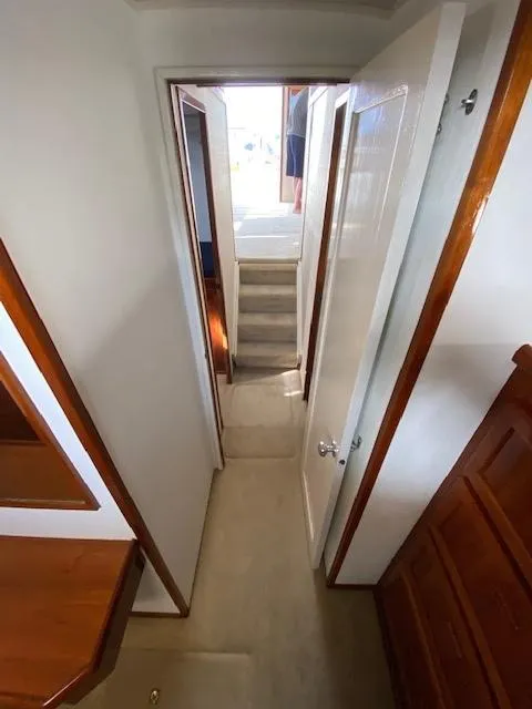 Slide: The Image of Interior hallway of 1973 Uniflite 42 Flybridge yacht with wooden accents. - 20