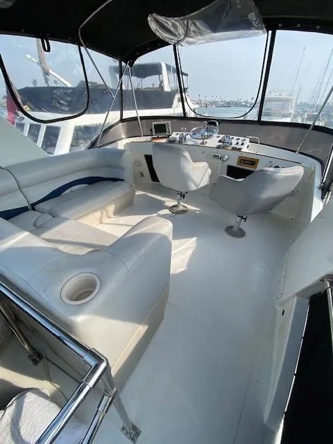 Slide: The Image of 1973 Uniflite 42 Flybridge interior with helm, seating, and panoramic windows. - 24