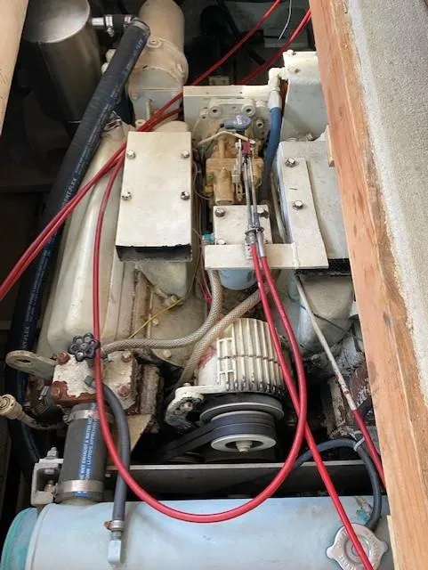 Slide: The Image of 1973 Uniflite 42 Flybridge engine with visible components and red wiring. - 27