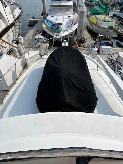 Slide: The Image of 1973 Uniflite 42 Flybridge yacht docked at marina, covered deck, surrounded by other boats. - 9