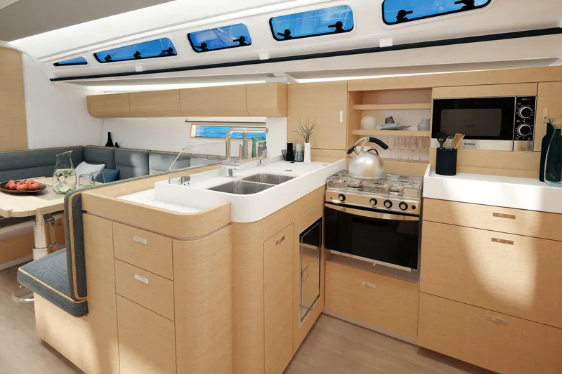 Slide: The Image of 2025 Dehler 46 sailing yacht with blue and black sails on open water. - 26