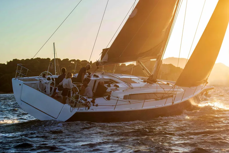 Slide: The Image of 2026 Dehler 46SQ sailing yacht on blue ocean with scenic coastal backdrop. - 42