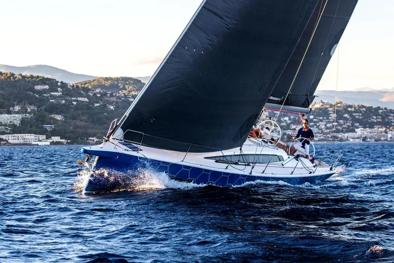 Slide: The Image of 2026 Dehler 46SQ sailing yacht on open water with crew navigating. - 44