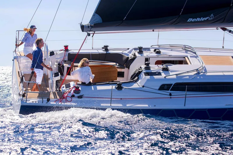 Slide: The Image of Couple sailing on a 2026 Dehler 46SQ yacht in sunny, blue ocean waters. - 49