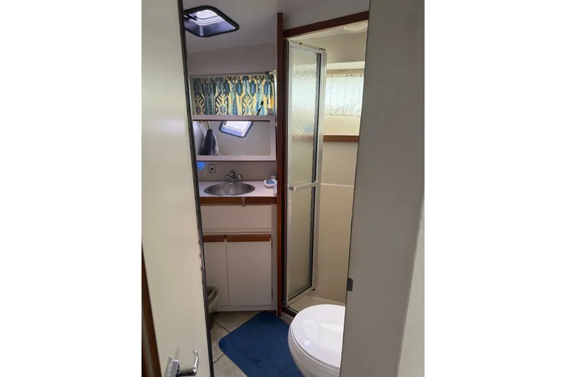 Slide: The Image of Bathroom interior of 1988 Carver 32 Montego boat with sink, shower, and toilet. - 17