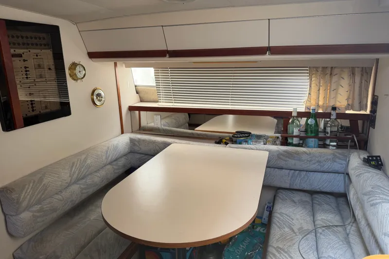 Slide: The Image of Interior of 1988 Carver 32 Montego yacht with dining area and seating. - 16