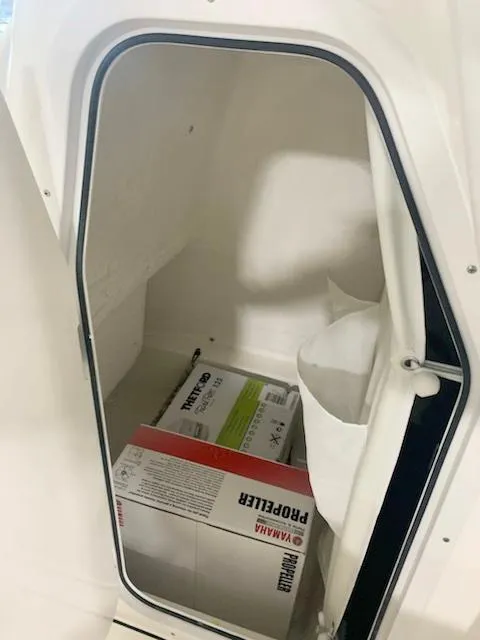 Slide: The Image of 2024 Key West 219 FS storage compartment with Yamaha propeller box. - 8