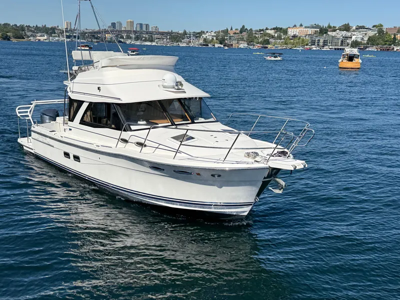Slide: The Image of 2020 Cutwater C 32 CB yacht cruising on a sunny day in a scenic harbor. - 17