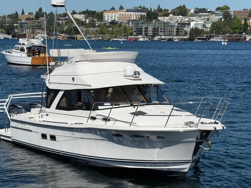 Slide: The Image of 2020 Cutwater C 32 CB boat on a scenic waterfront. - 19