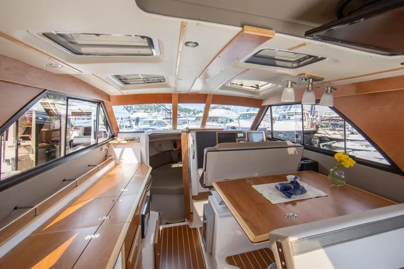 Slide: The Image of Interior of 2020 Cutwater C 32 CB boat with wood accents and dining area. - 5