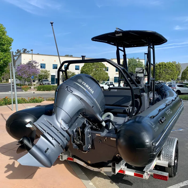 Slide: The Image of 2023 Zodiac Pro 6.5 boat with Yamaha outboard motor on a trailer. - 2