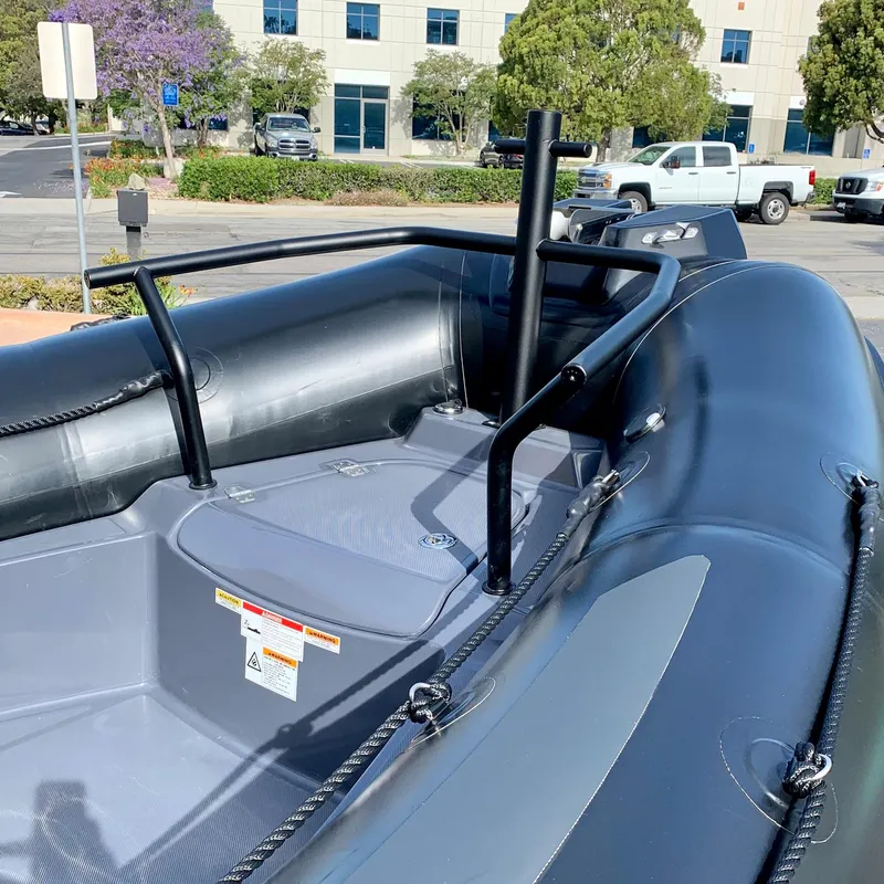 Slide: The Image of 2023 Zodiac Pro 6.5 inflatable boat interior with black railings and gray seating. - 4