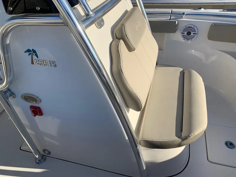 Slide: The Image of 2024 Key West 239 FS boat interior with cushioned seating and stainless steel railing. - 12