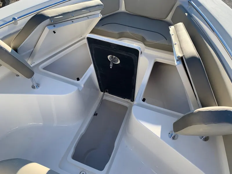 Slide: The Image of 2024 Key West 239 FS boat interior with storage compartments and seating. - 13