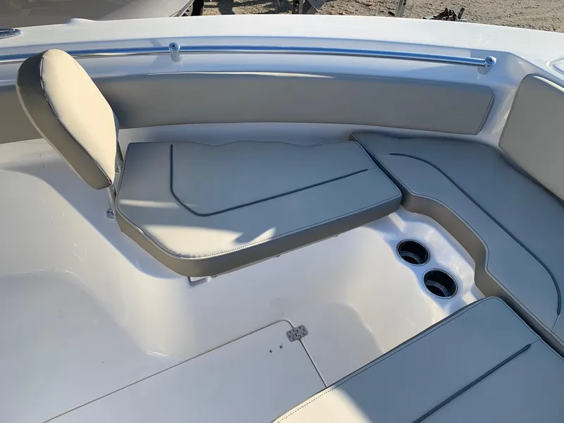 Slide: The Image of 2024 Key West 239 FS boat interior seating area with cup holders. - 15